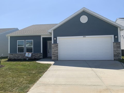 a home with a white garage door in front of it